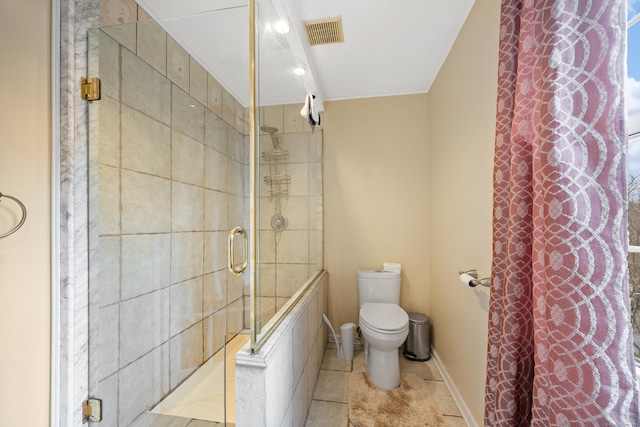 bathroom featuring toilet and an enclosed shower