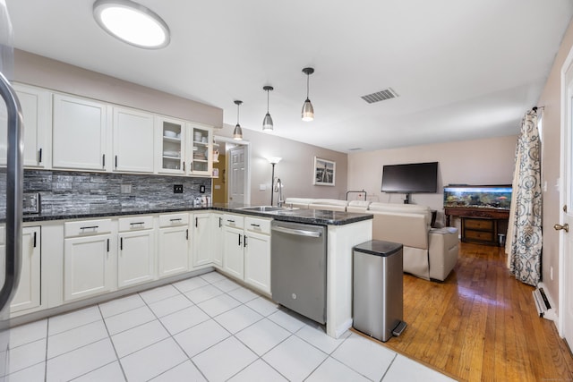 kitchen featuring white cabinets, sink, pendant lighting, light tile patterned floors, and dishwasher