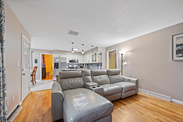 living room featuring light hardwood / wood-style flooring and sink