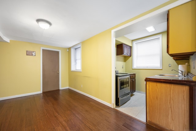 kitchen featuring sink, light hardwood / wood-style floors, and electric stove