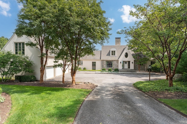 view of front facade with a front yard and a garage