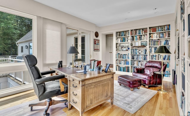 office area with light hardwood / wood-style flooring and french doors