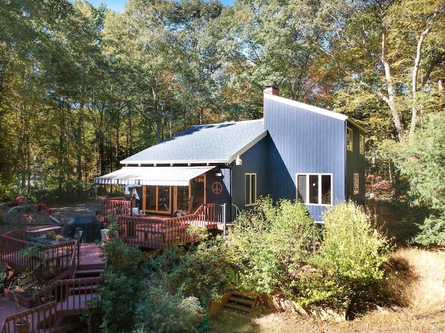 rear view of property featuring a deck