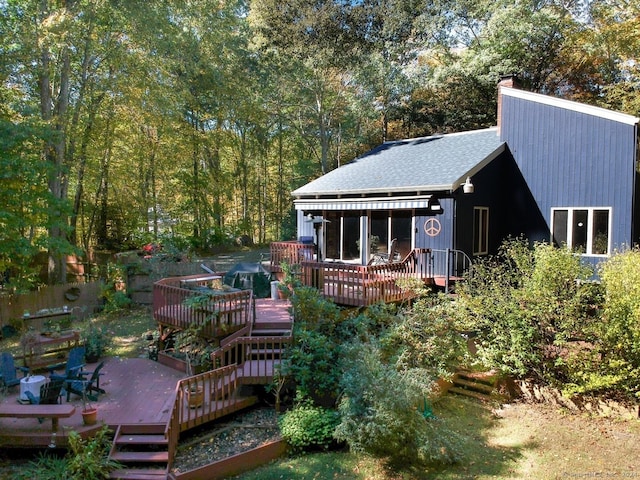 back of property with a wooden deck