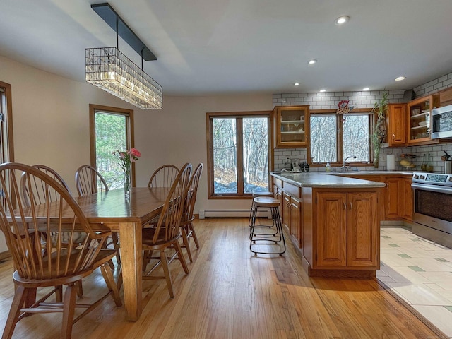 kitchen with a center island, plenty of natural light, light hardwood / wood-style floors, and stainless steel appliances