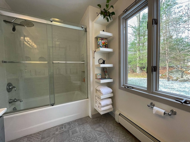 bathroom with a baseboard heating unit, a healthy amount of sunlight, and enclosed tub / shower combo