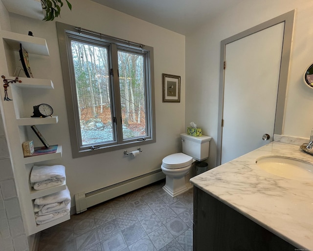 bathroom featuring vanity, toilet, and a baseboard heating unit