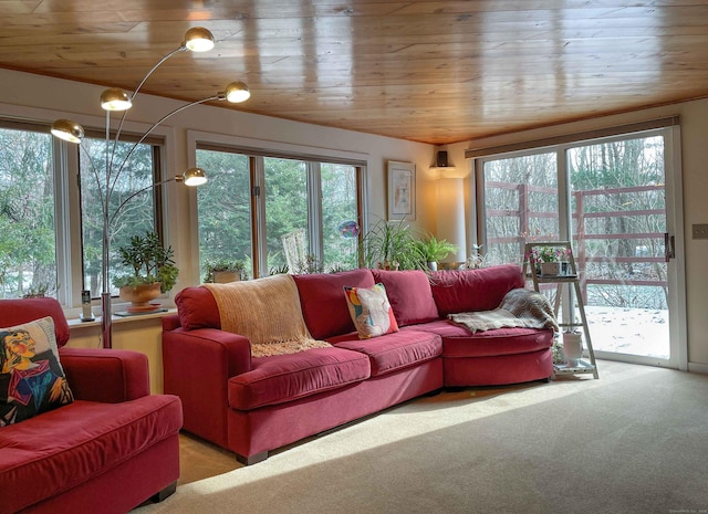 carpeted living room featuring wood ceiling