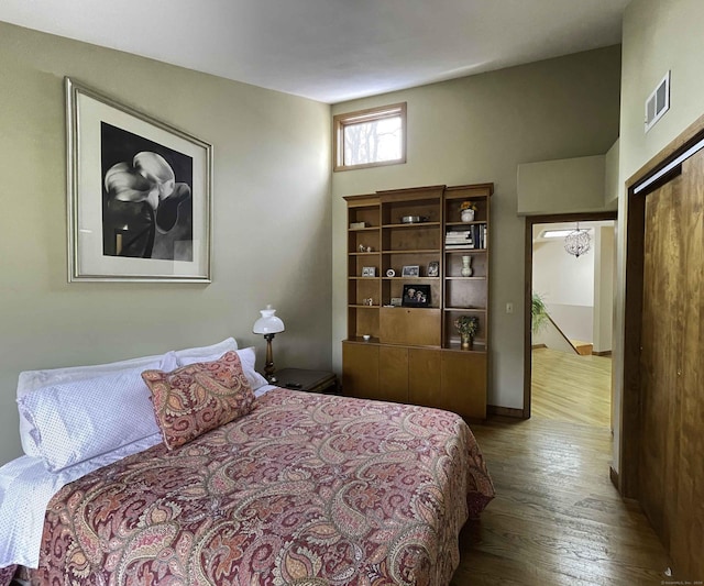 bedroom featuring wood-type flooring and a closet