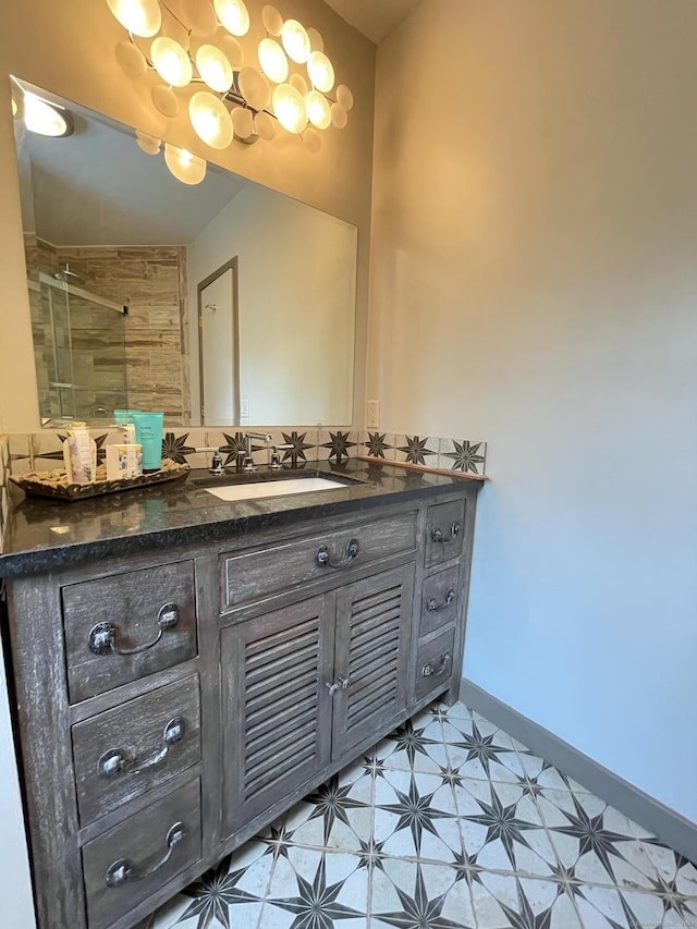 bathroom featuring a tile shower and vanity