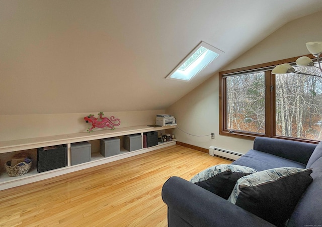 additional living space with baseboard heating, lofted ceiling with skylight, and wood-type flooring