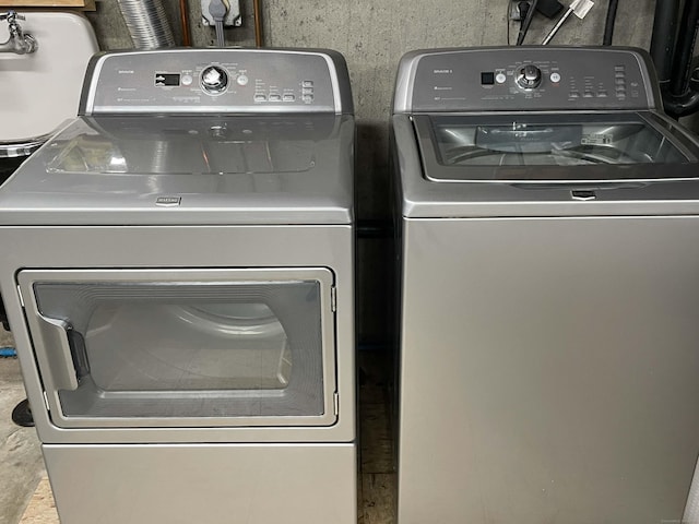 clothes washing area with washing machine and dryer