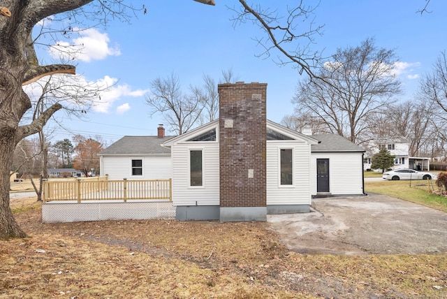 back of house with a deck