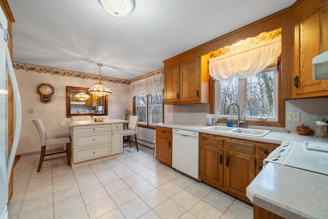 kitchen featuring decorative light fixtures, sink, decorative backsplash, and white appliances