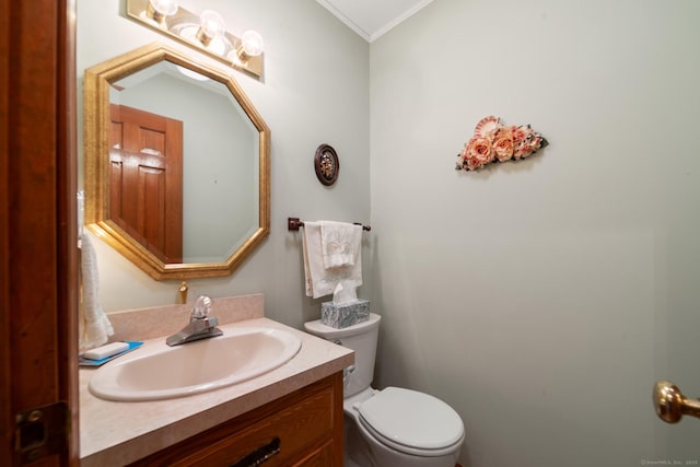 bathroom featuring toilet, vanity, and crown molding