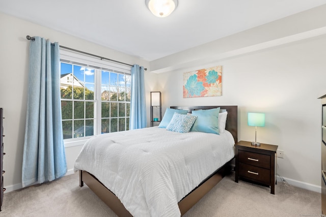 bedroom featuring light carpet