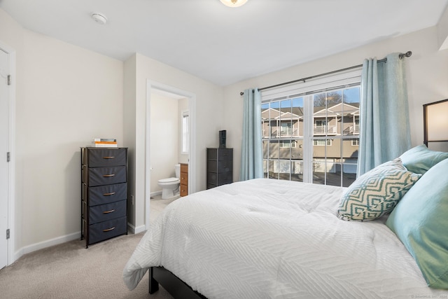 carpeted bedroom with connected bathroom