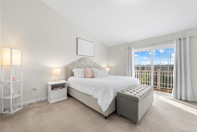 bedroom with access to outside, light colored carpet, and lofted ceiling