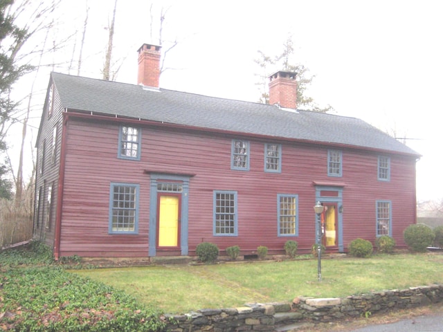 colonial-style house with a front yard