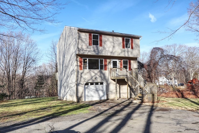 view of property with a front yard and a garage