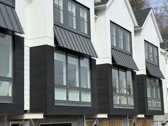 view of home's exterior featuring a standing seam roof, metal roof, and roof with shingles