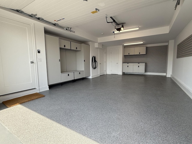 785 Post Rd E Unit 102, Westport, CT 06880 - garage featuring baseboards and a garage door opener