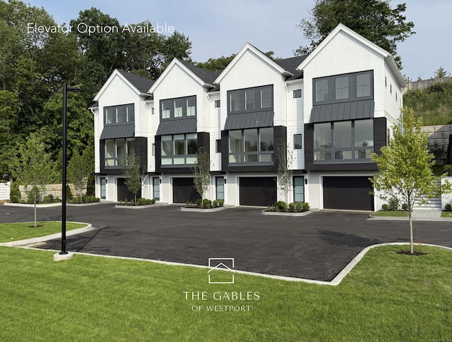 785 Post Rd E Unit 102, Westport, CT 06880 - view of front facade featuring a standing seam roof, metal roof, a front yard, an attached garage, and driveway