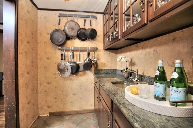 interior space with tile patterned floors, ornamental molding, and sink