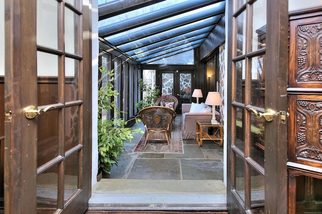 unfurnished sunroom featuring french doors and lofted ceiling