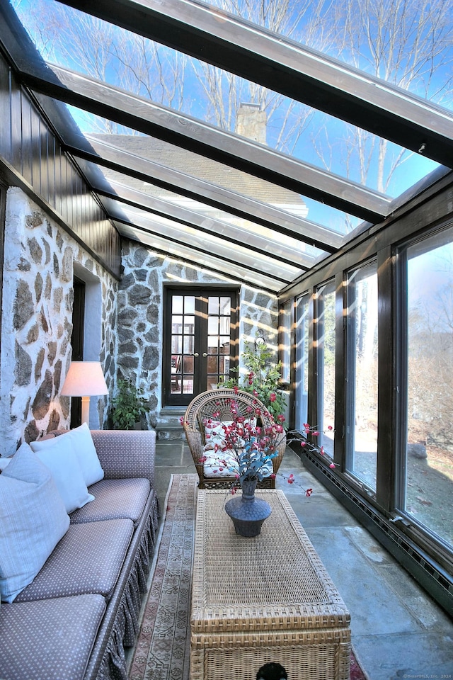 sunroom featuring a healthy amount of sunlight and lofted ceiling