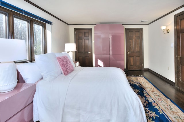 bedroom featuring crown molding and wood-type flooring