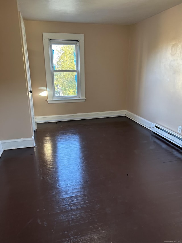 spare room featuring dark wood-type flooring