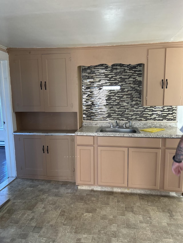 kitchen featuring tasteful backsplash and sink