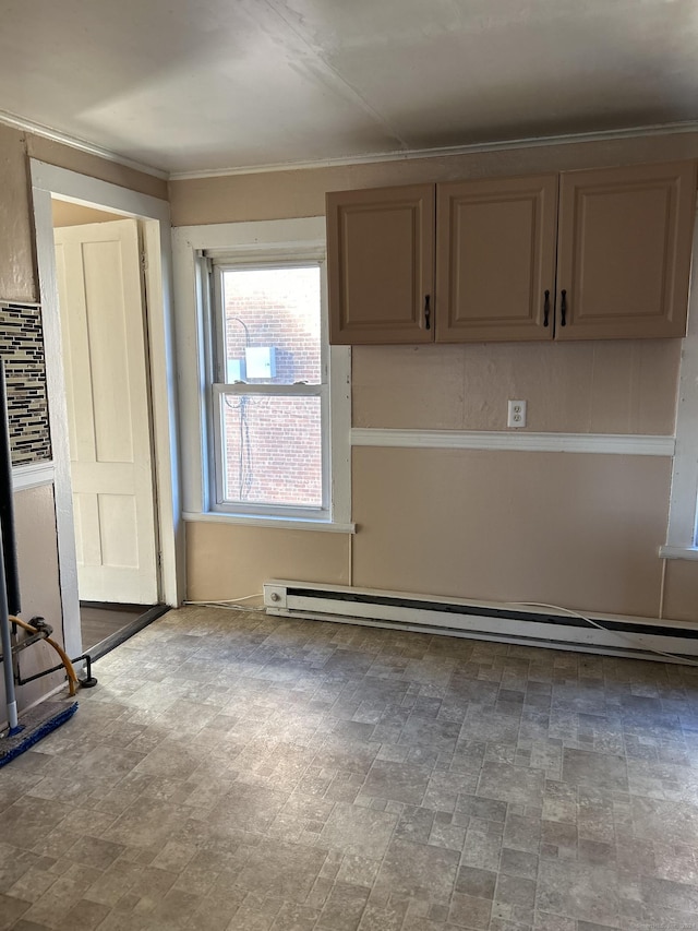 kitchen with light brown cabinetry and baseboard heating