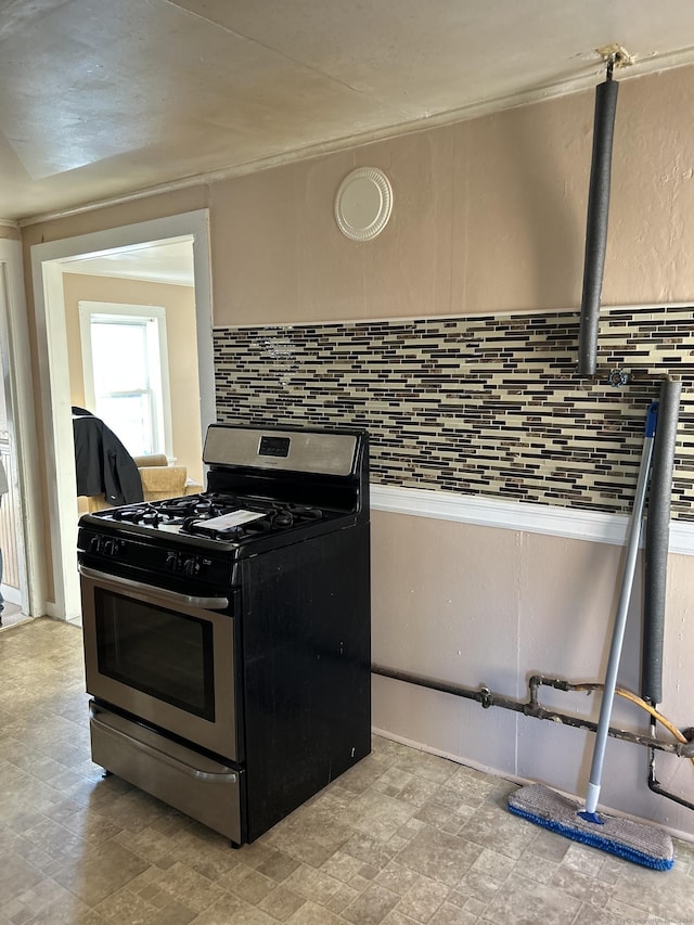 kitchen with stainless steel range with gas cooktop and backsplash