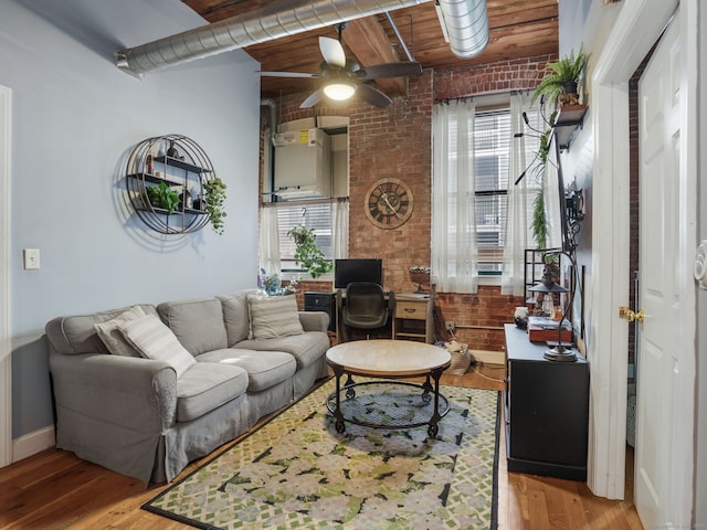 living room featuring light wood-type flooring, wooden ceiling, a healthy amount of sunlight, and brick wall