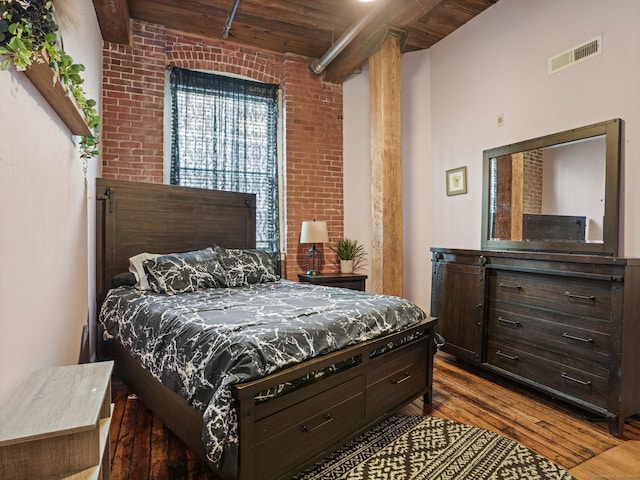 bedroom featuring brick wall, dark hardwood / wood-style flooring, and wood ceiling