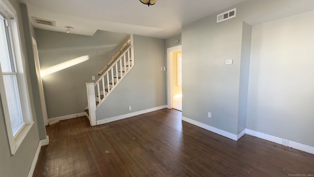 empty room with dark hardwood / wood-style flooring