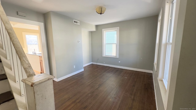 empty room with dark hardwood / wood-style flooring