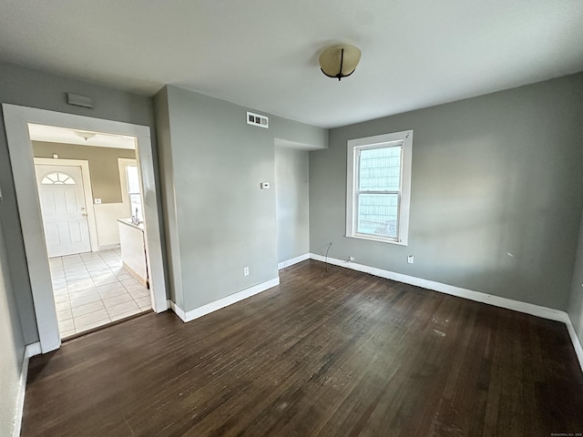 unfurnished room featuring dark wood-type flooring