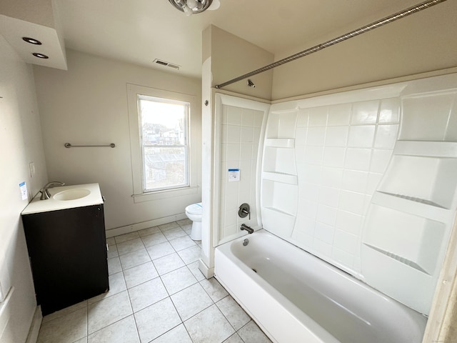 full bathroom featuring tile patterned floors, vanity, toilet, and tiled shower / bath