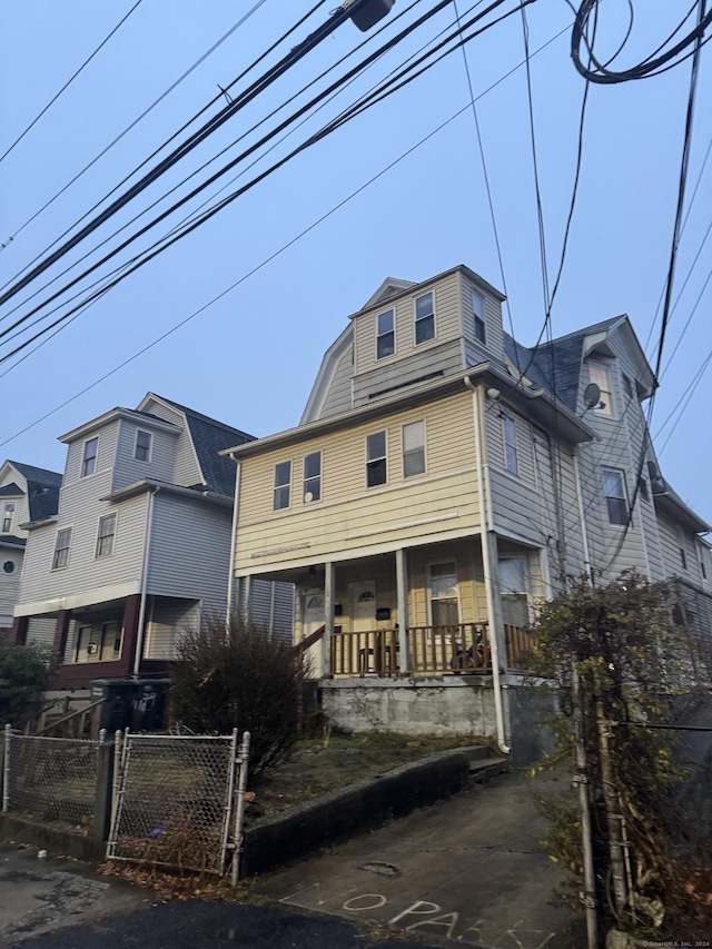 rear view of house featuring a porch