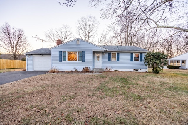 single story home with a front yard and a garage