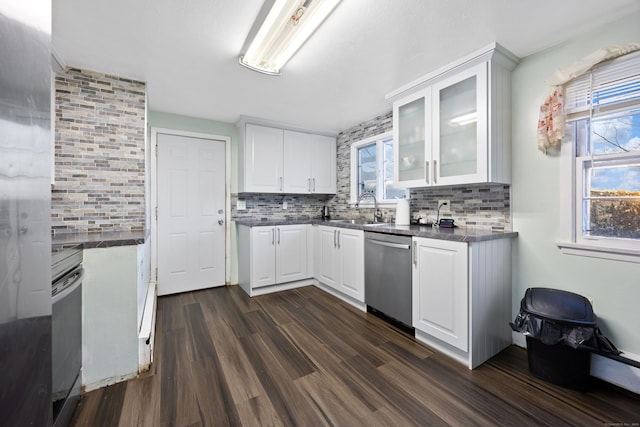 kitchen featuring stainless steel dishwasher, plenty of natural light, white cabinetry, and backsplash