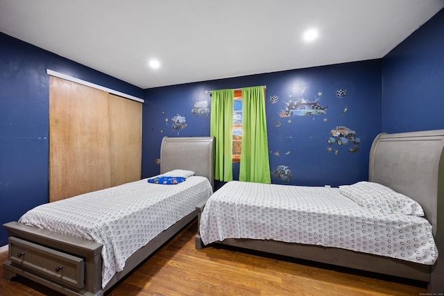 bedroom with hardwood / wood-style flooring and a closet