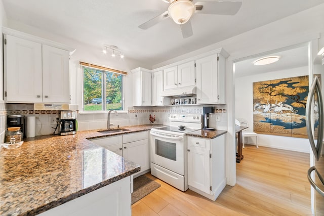 kitchen featuring white electric range oven, white cabinetry, and sink