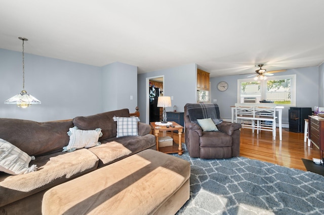 living room with ceiling fan and hardwood / wood-style floors