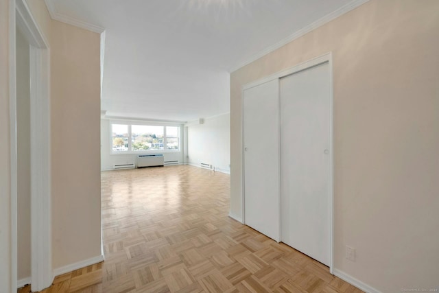 corridor with ornamental molding, baseboard heating, and light parquet floors