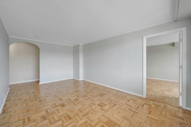 spare room featuring ornamental molding and light parquet flooring