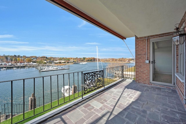 balcony featuring a water view